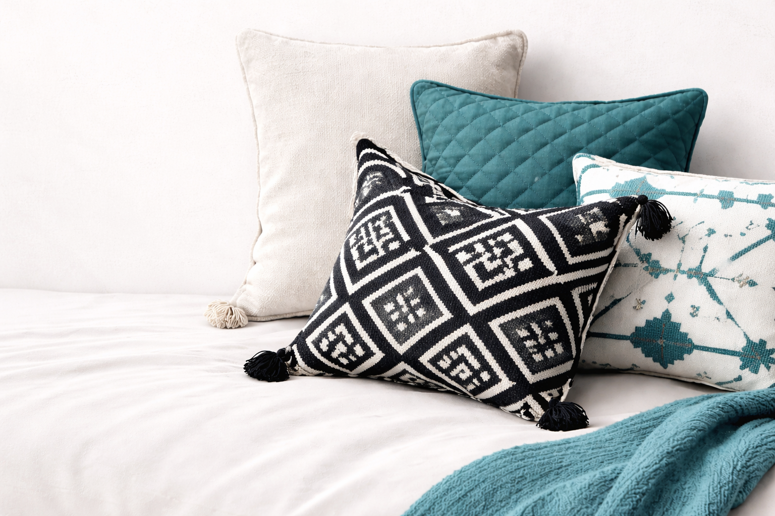 A collection of nude-colored cushions on a sofa.